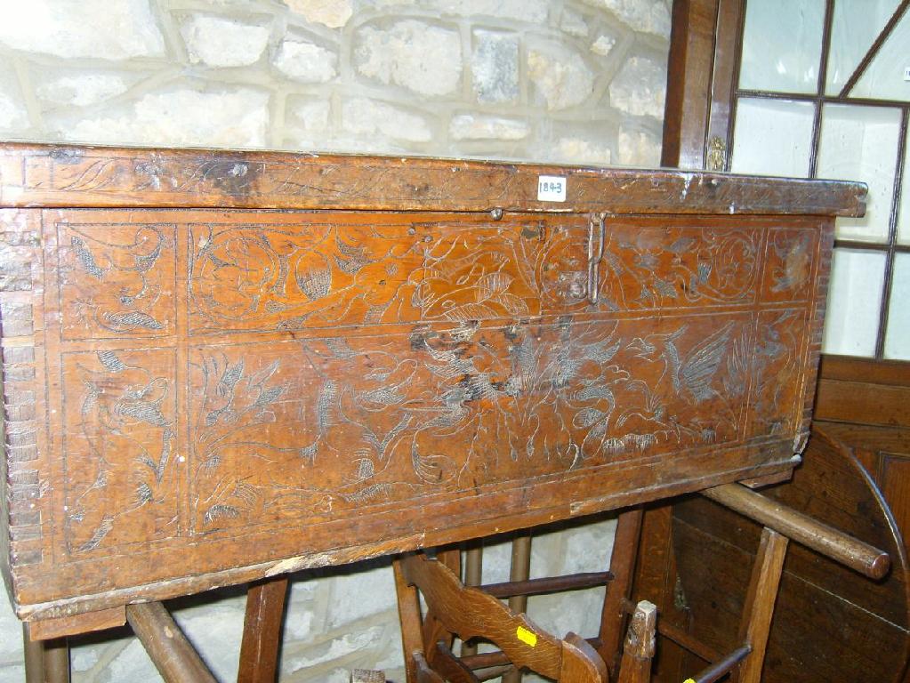 Appraisal: An th century cedar wood coffer with scratch carved detail