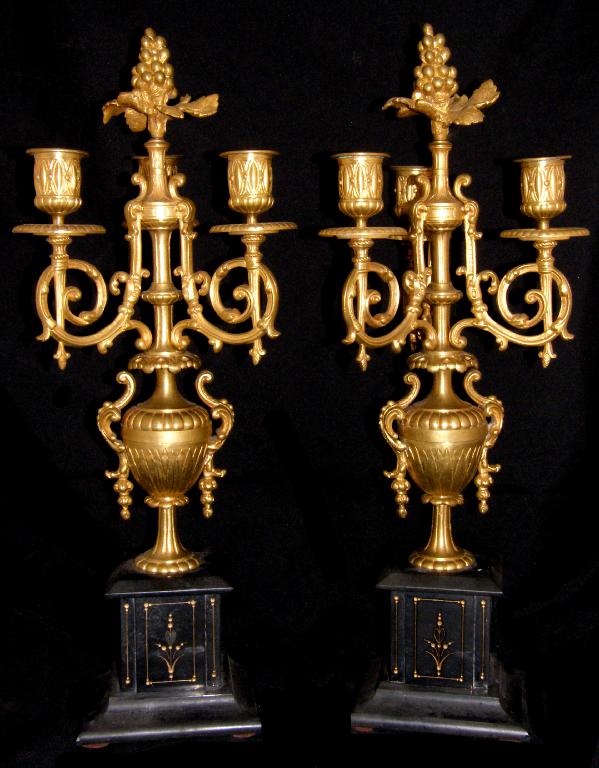 Appraisal: Pair of ornate gilt metal three light candelabra supported upon