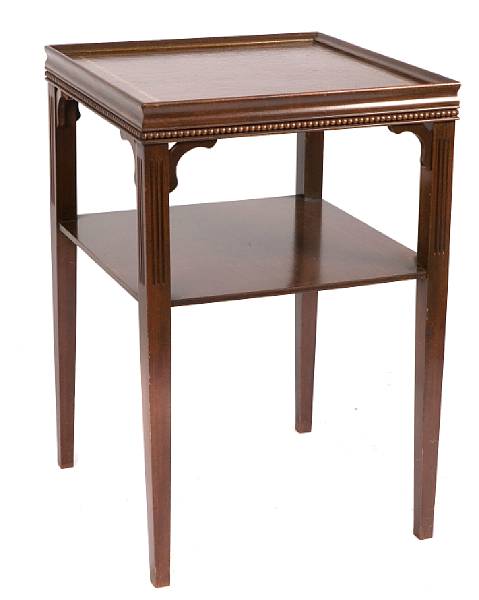 Appraisal: A pair of leather inset mahogany end tables together with