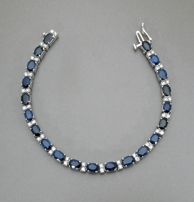 Appraisal: DIAMOND BLUE SAPPHIRE AND FOURTEEN KARAT WHITE GOLD LINE BRACELET