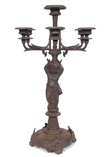 Appraisal: A pair of seven light cast iron figural candelabra height