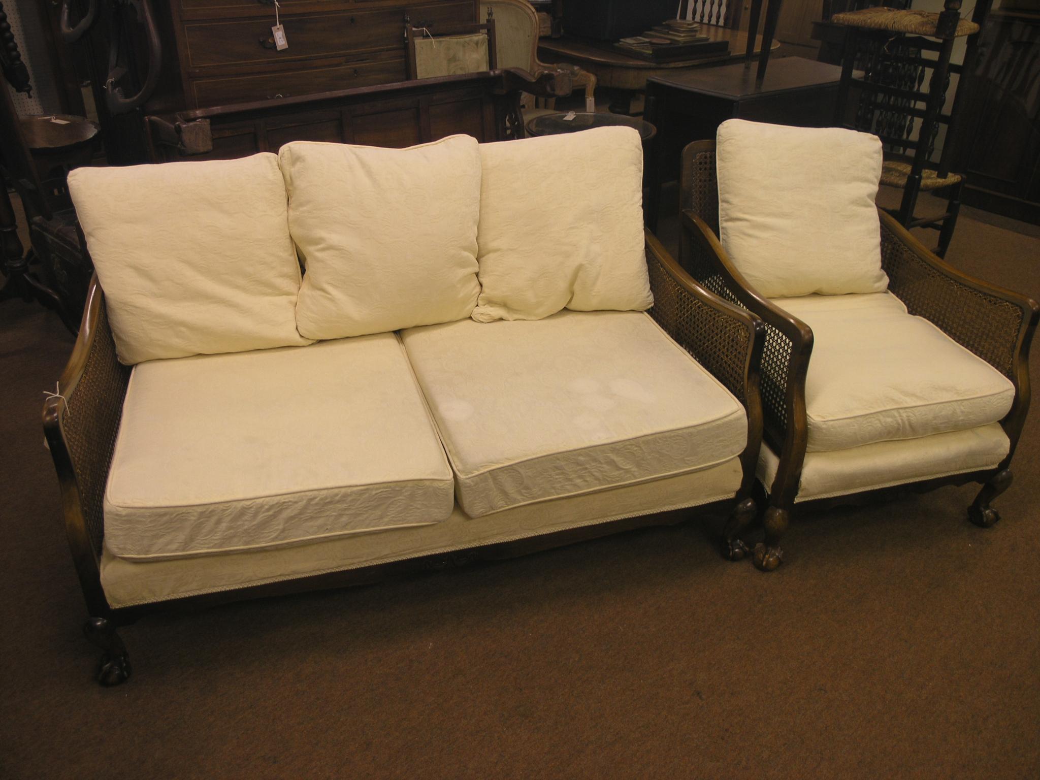 Appraisal: A bergere settee and matching armchair single-caned walnut frame with