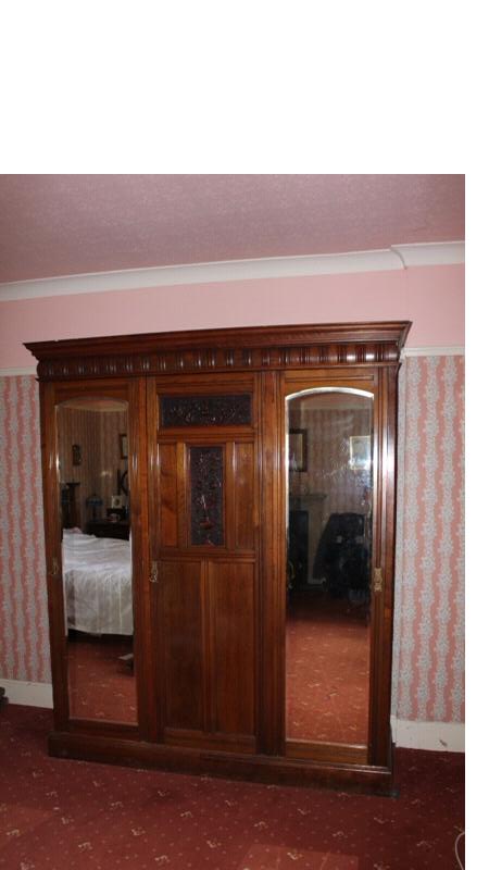 Appraisal: A late Victorian walnut wardrobe compactum with moulded cornice and