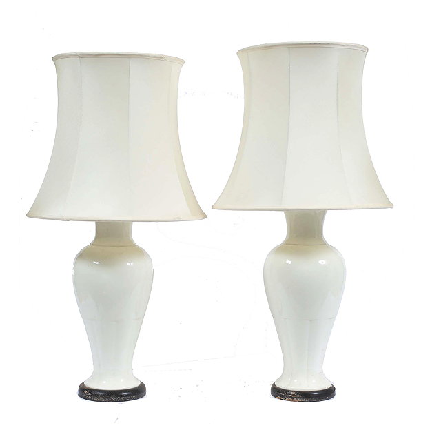 Appraisal: A PAIR OF CREAM GLAZED POTTERY TABLE LAMPS of baluster