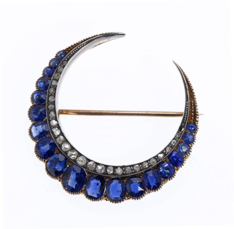 Appraisal: AN ANTIQUE DIAMOND AND SAPPHIRE CRESCENT BROOCH with a graduated