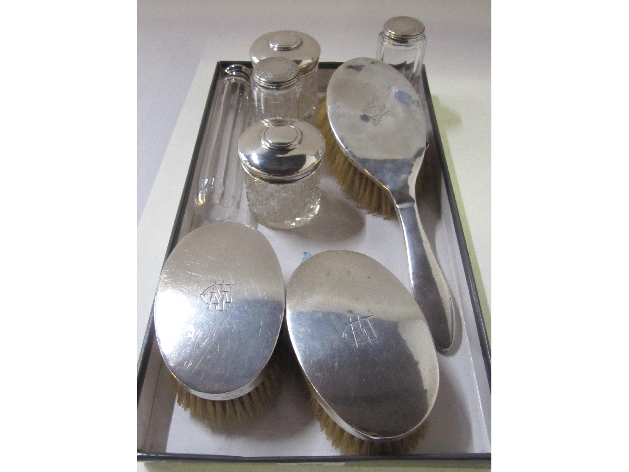 Appraisal: A lot comprising three silver backed brushes and five silver