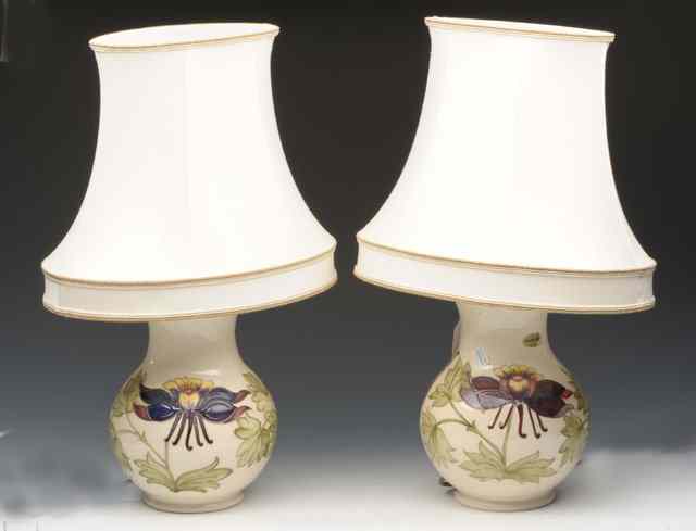 Appraisal: A PAIR OF MOORCROFT CREAM GROUND TABLE LAMPS with floral