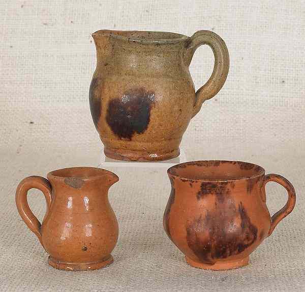 Appraisal: Three Pennsylvania miniature redware pitchers th c tallest -