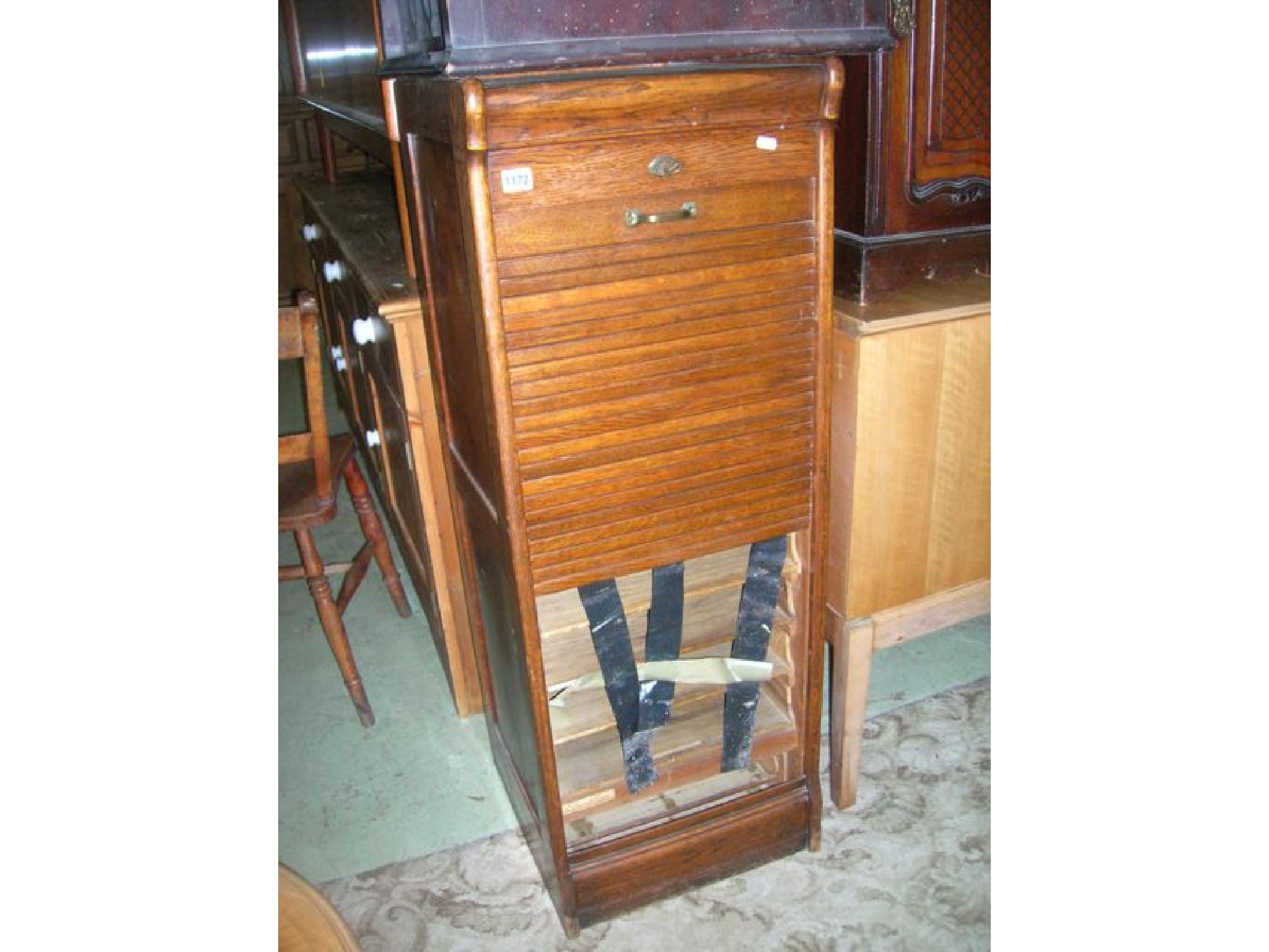 Appraisal: An Edwardian oak framed pedestal filing cabinet enclosed by a