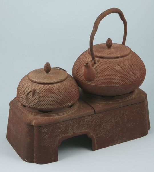 Appraisal: Group of two antique Japanese iron teapots on iron base