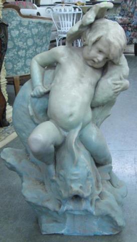 Appraisal: A ceramic garden statue depicting putti riding a fish high