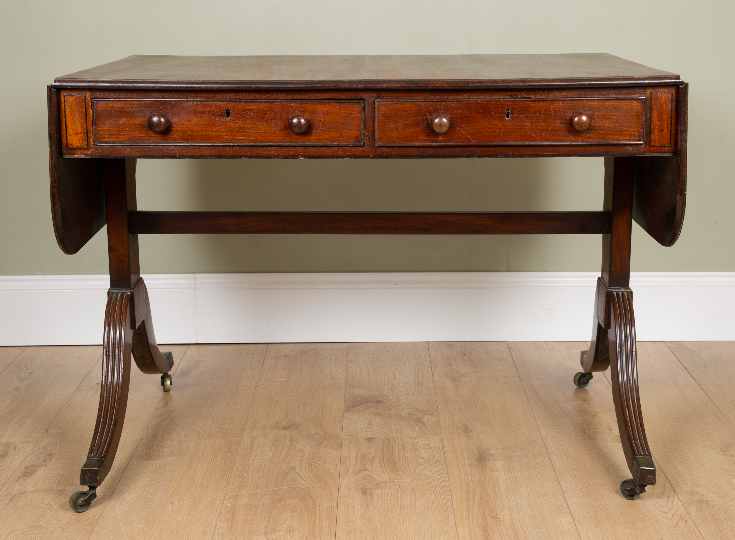 Appraisal: A George III mahogany sofa table with two frieze drawers