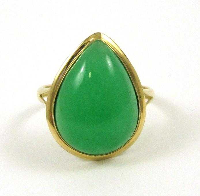 Appraisal: GREEN JADE AND FOURTEEN KARAT GOLD RING set with a