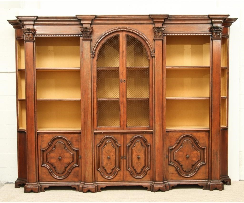 Appraisal: Massive Italian walnut three-piece bookcase cabinet with fabric-lined shelving made