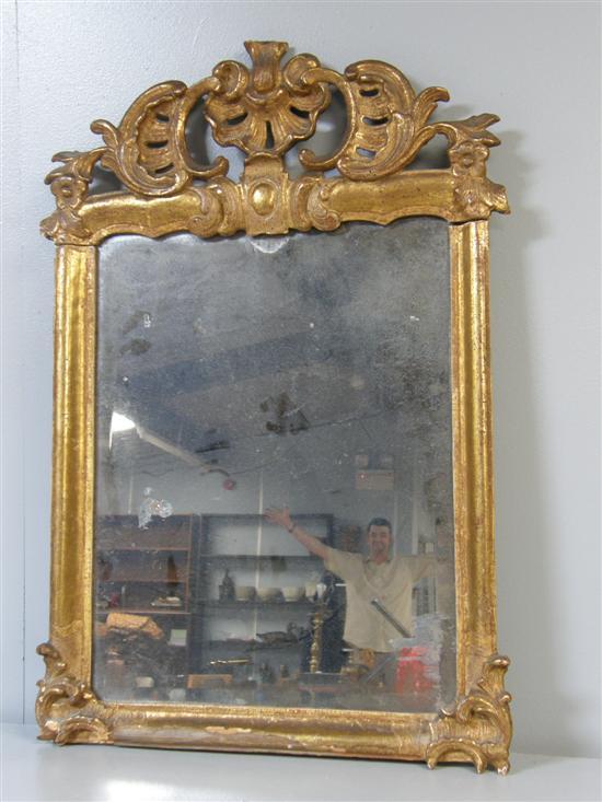 Appraisal: th century carved wood gilt framed looking glass the top