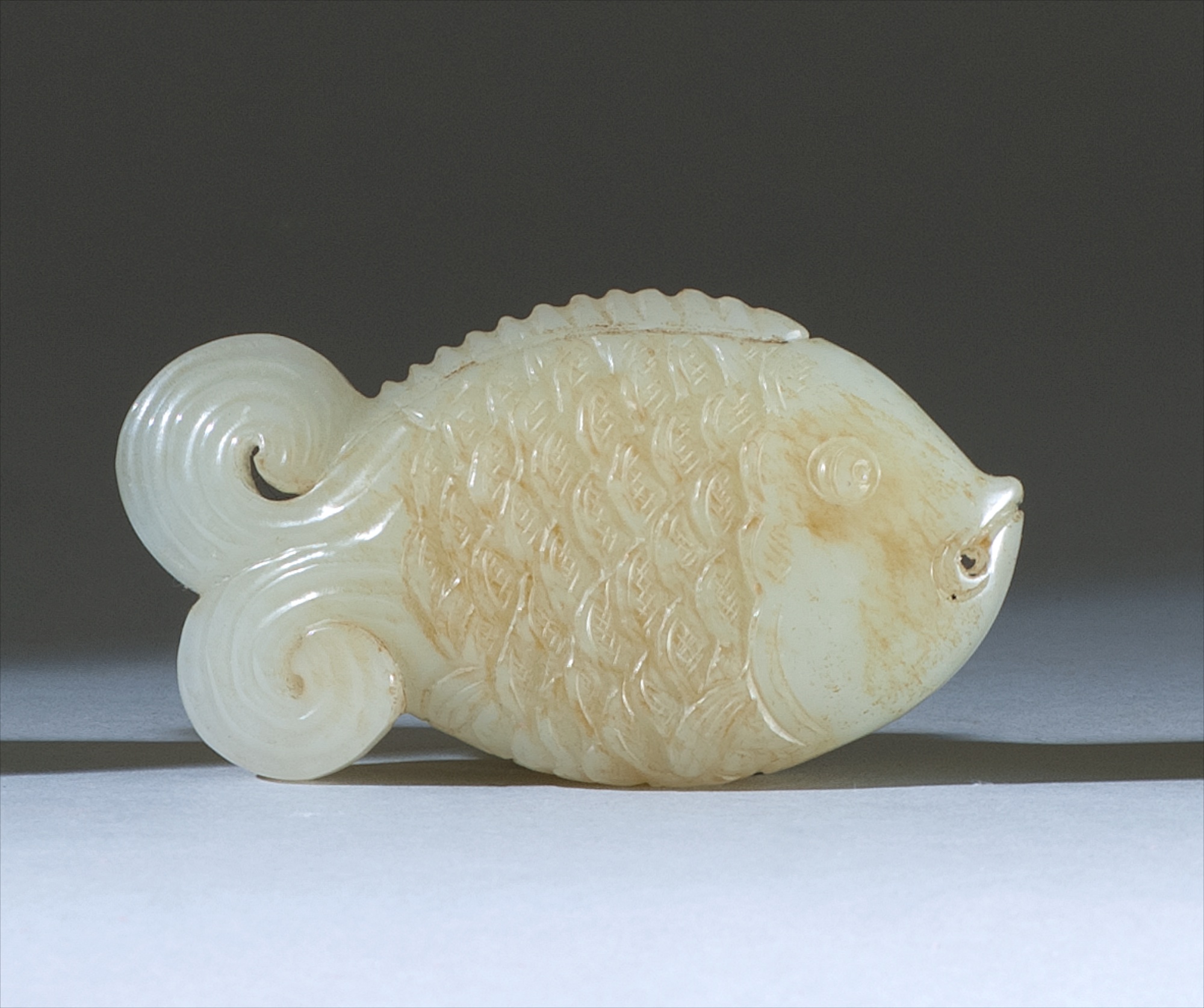 Appraisal: WHITE AND RUSSET JADE PENDANT th CenturyIn the form of