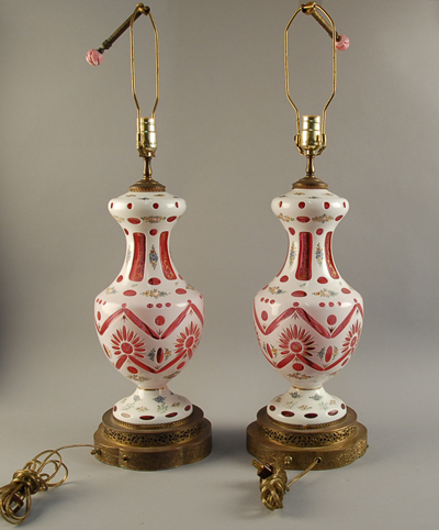 Appraisal: A Pair of Bohemian Cased Glass Lamps white cut to