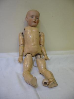 Appraisal: A German bisque head boy doll with intaglio eyes closed