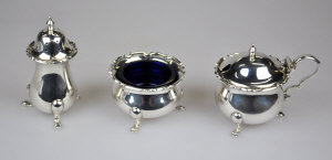 Appraisal: A three piece silver condiment set with blue glass liners