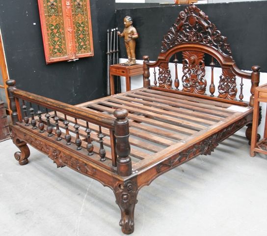 Appraisal: A four poster Calcutta bed headboard with central pierced carved