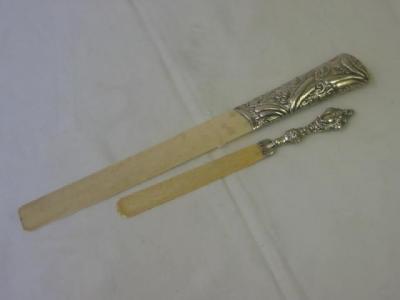 Appraisal: A VICTORIAN PAPER KNIFE the ivory blade on foliate embossed