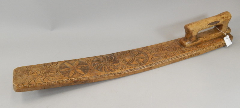 Appraisal: A mangle board of shaped outline with carved handle set