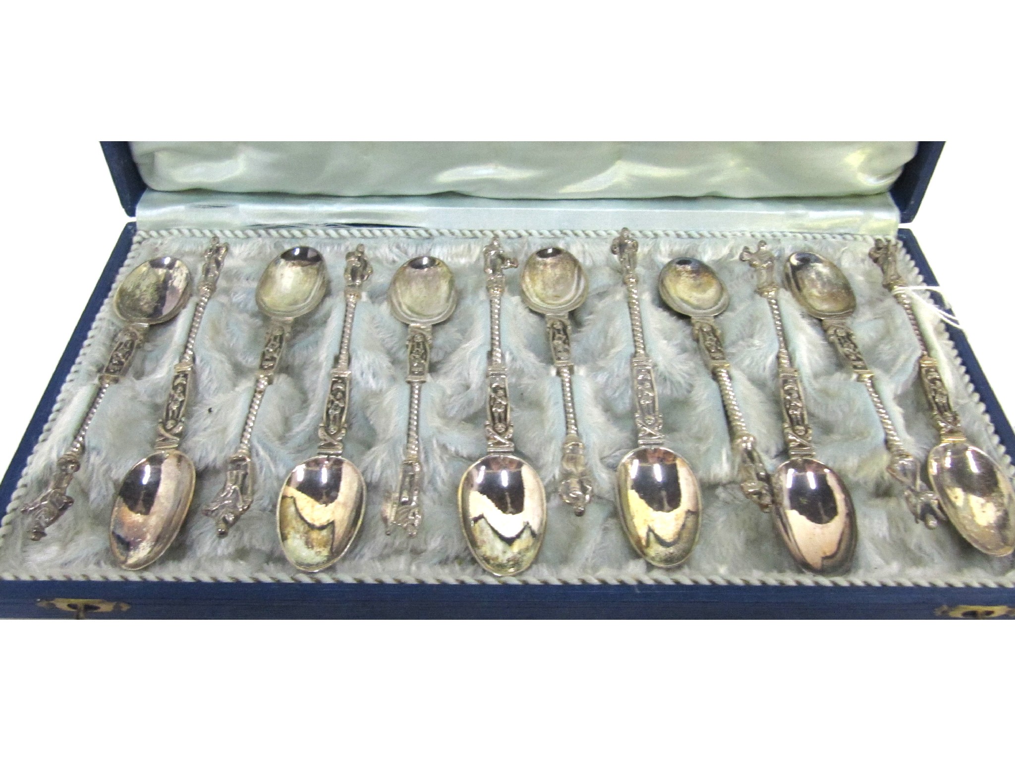 Appraisal: A cased set of twelve EP spoons with figural knopps