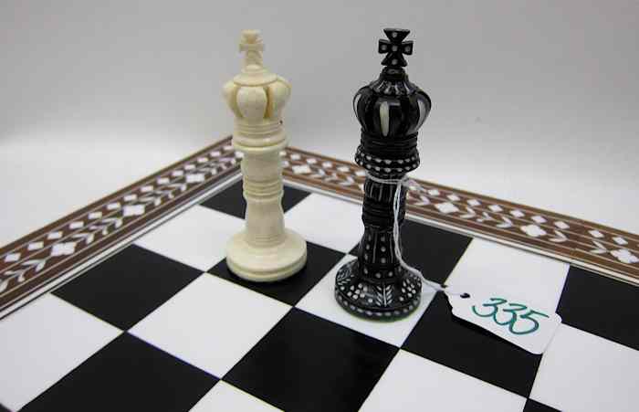 Appraisal: HAND CARVED BONE CHESS SET WITH BOARD in natural white