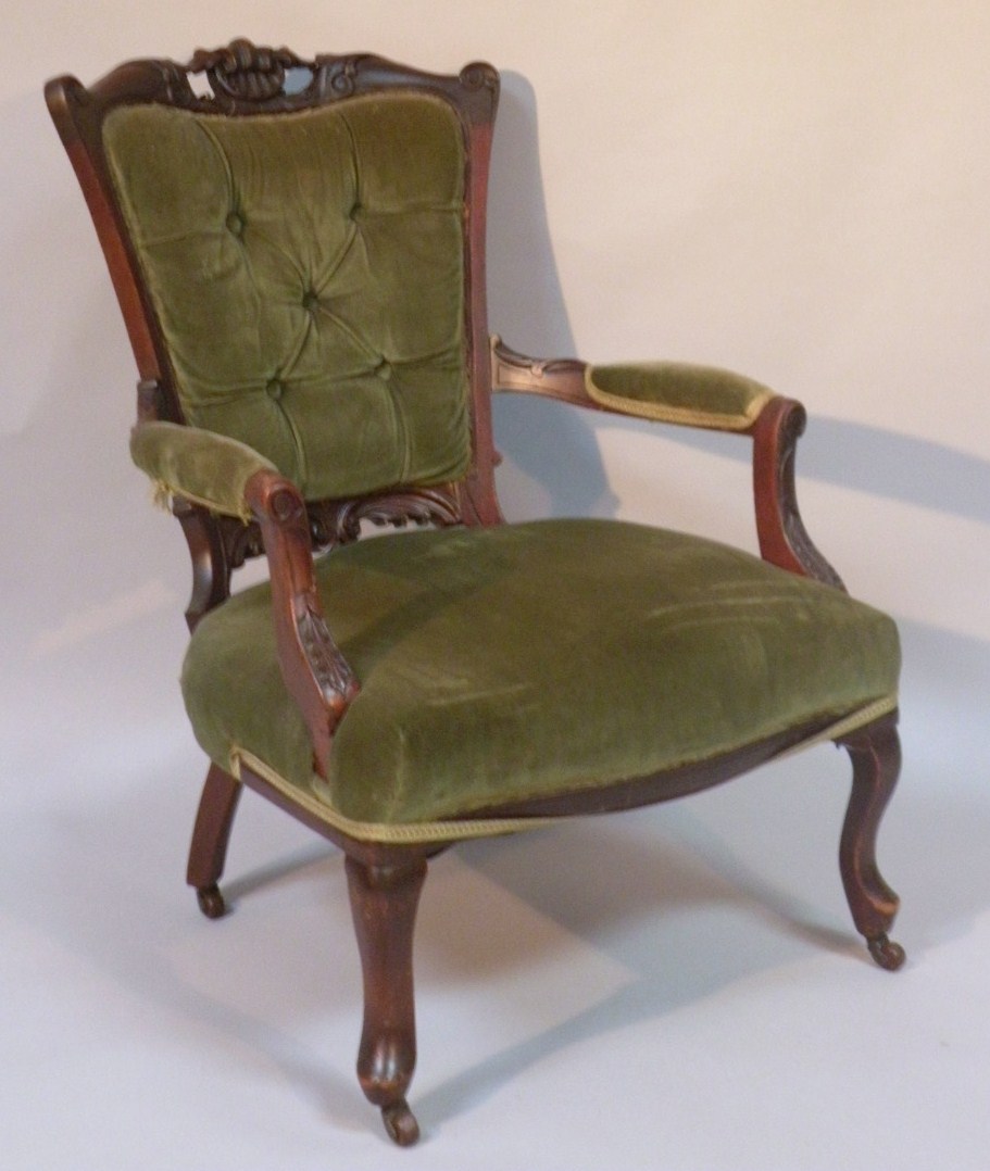 Appraisal: A Victorian mahogany armchair with a carved shell scroll back