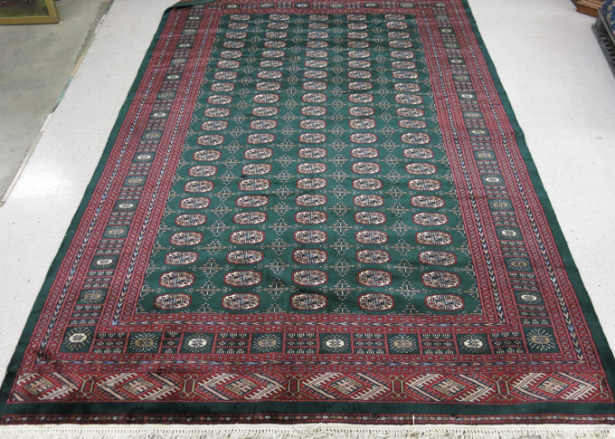 Appraisal: SIGNED GREEN FIELD BOKHARA CARPET Pakistan or India hand knotted