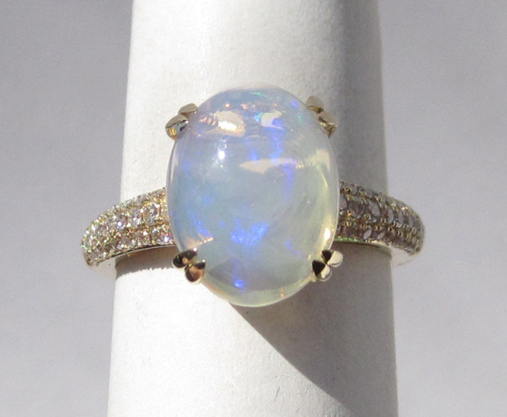 Appraisal: OPAL DIAMOND AND FOURTEEN KARAT GOLD RING with round-cut diamonds