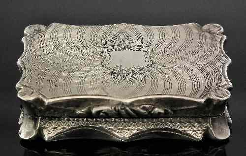 Appraisal: A Victorian silver rectangular vinaigrette of shaped outline with engraved