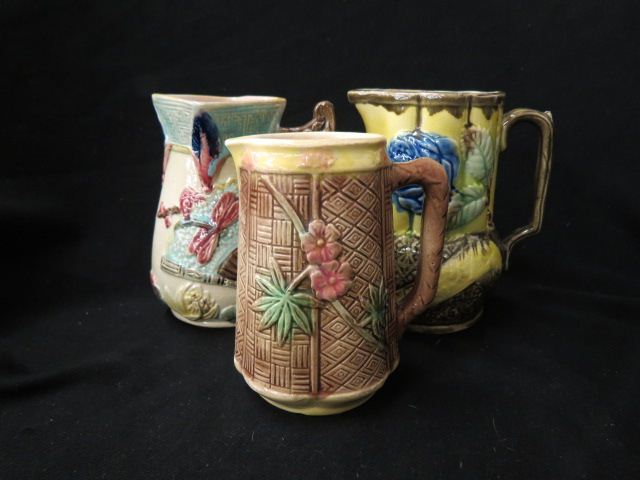 Appraisal: Majolica Pottery Milk Pitchers dragonfly fan rose other floral to