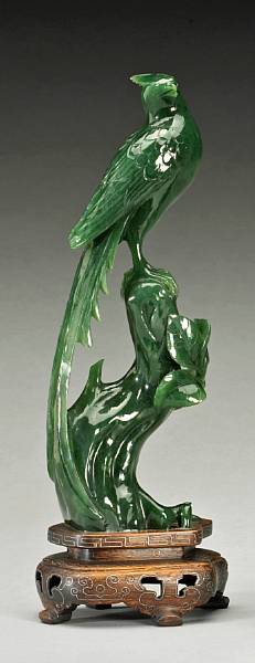 Appraisal: A 'spinach' jade phoenix th Century Seen atop a fantastic