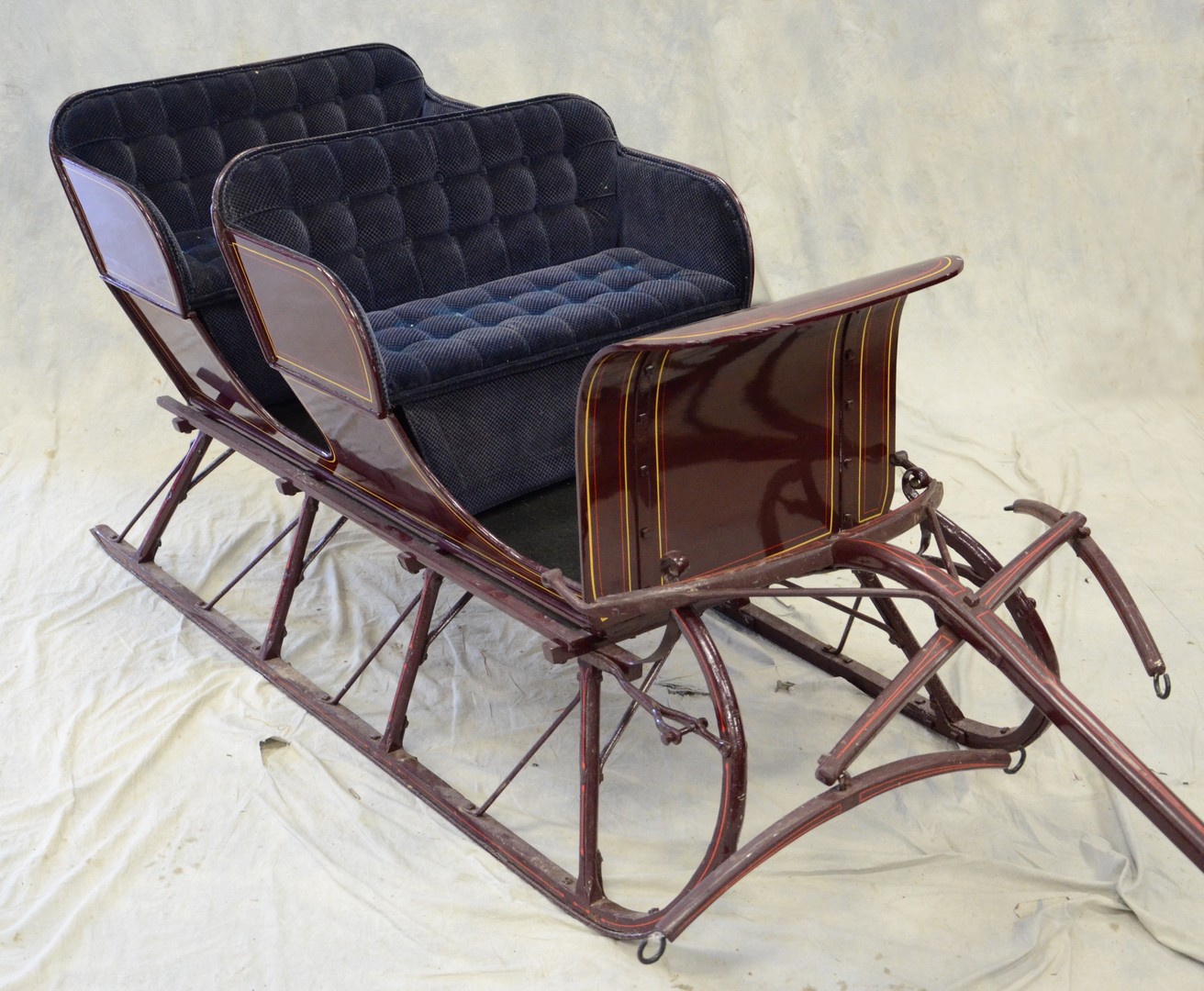 Appraisal: Child's -seat sleigh with pony hitches tufted blue velvet upholstery