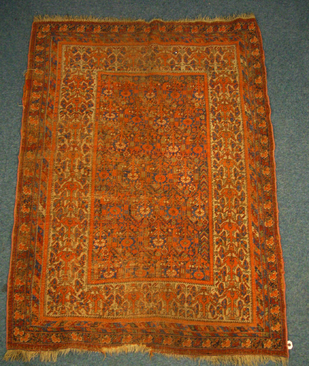 Appraisal: Rectangular orange and blue ground rug decorated with a floral