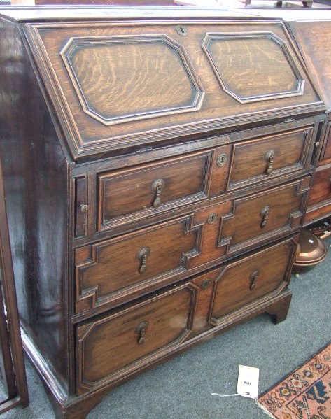 Appraisal: An early th century oak bureau the fall enclosing a