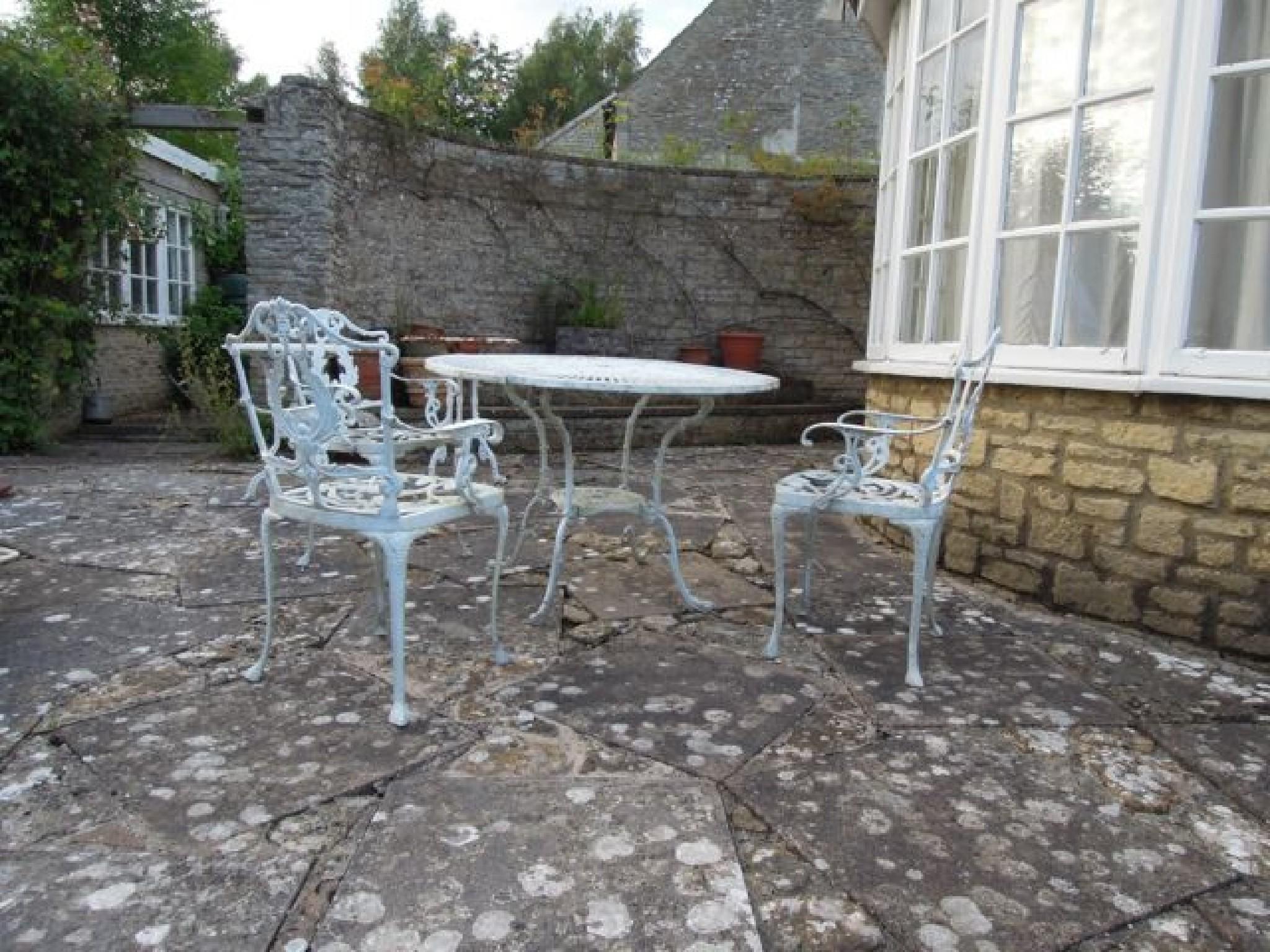 Appraisal: A cast aluminium garden table with pierced top together with