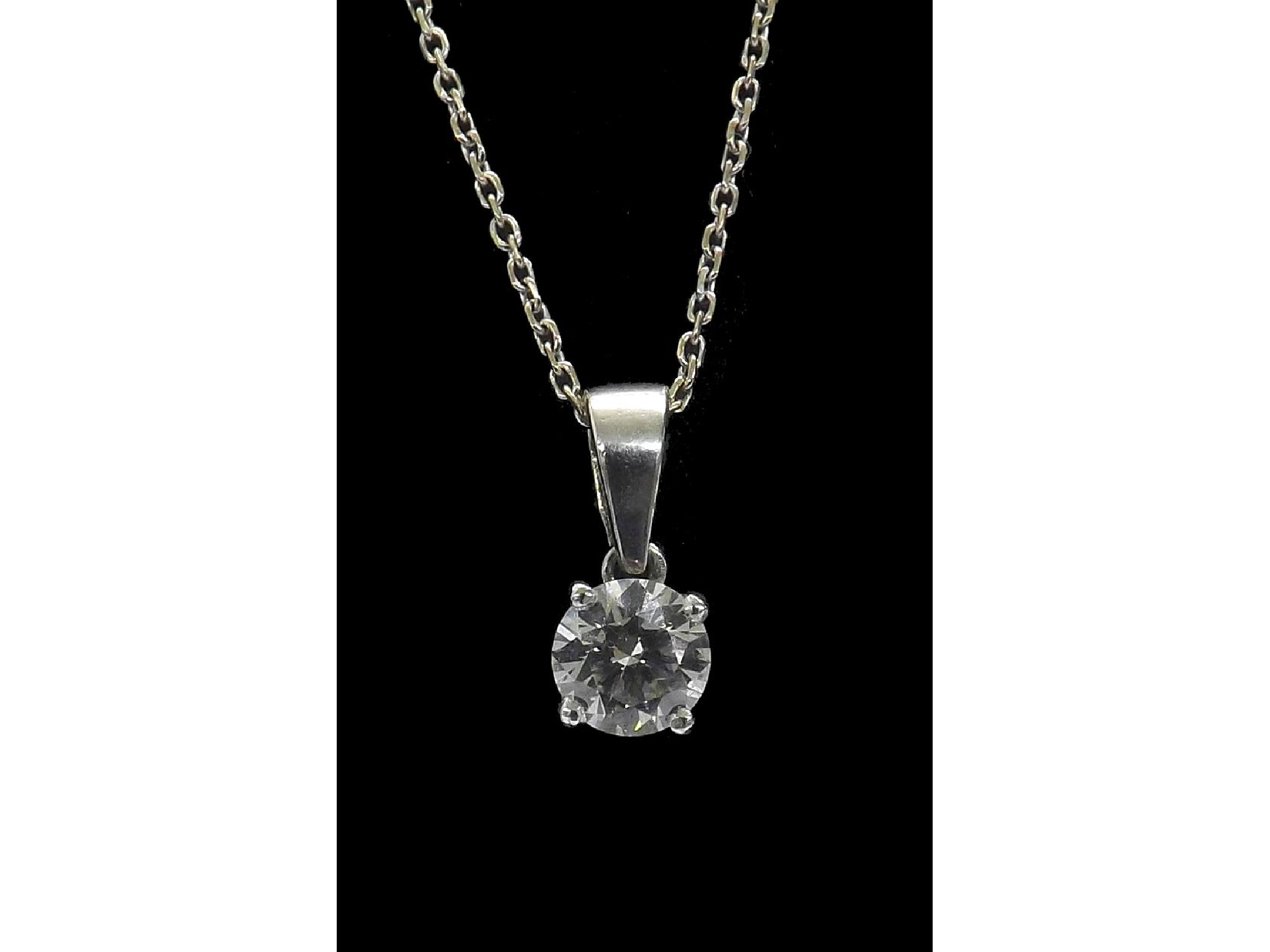 Appraisal: - -a Platinum solitaire round brilliant-cut diamond pendant on an