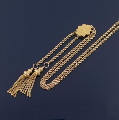 Appraisal: A gold twist link neckchain with two tassels and a