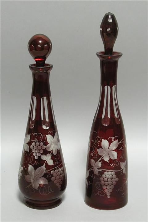 Appraisal: TWO SIMILAR BOHEMIAN GLASS DECANTERS Each decorated with a design