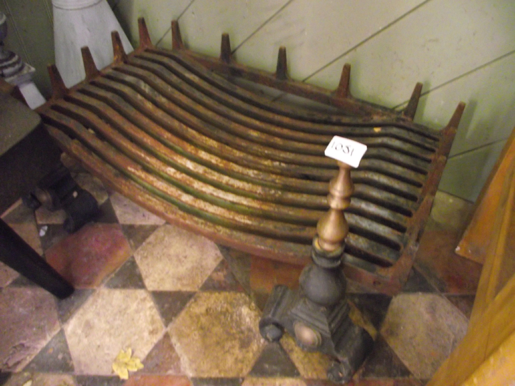 Appraisal: A heavy cast iron fire grate raised on a pair