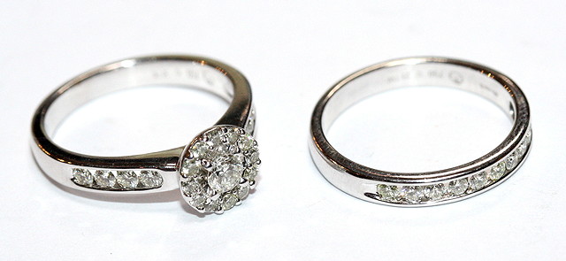 Appraisal: A CONTEMPORARY DIAMOND SET RING central brilliant cut diamond surrounded