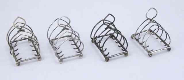 Appraisal: Four silver toast racks S S and H Ltd Birmingham