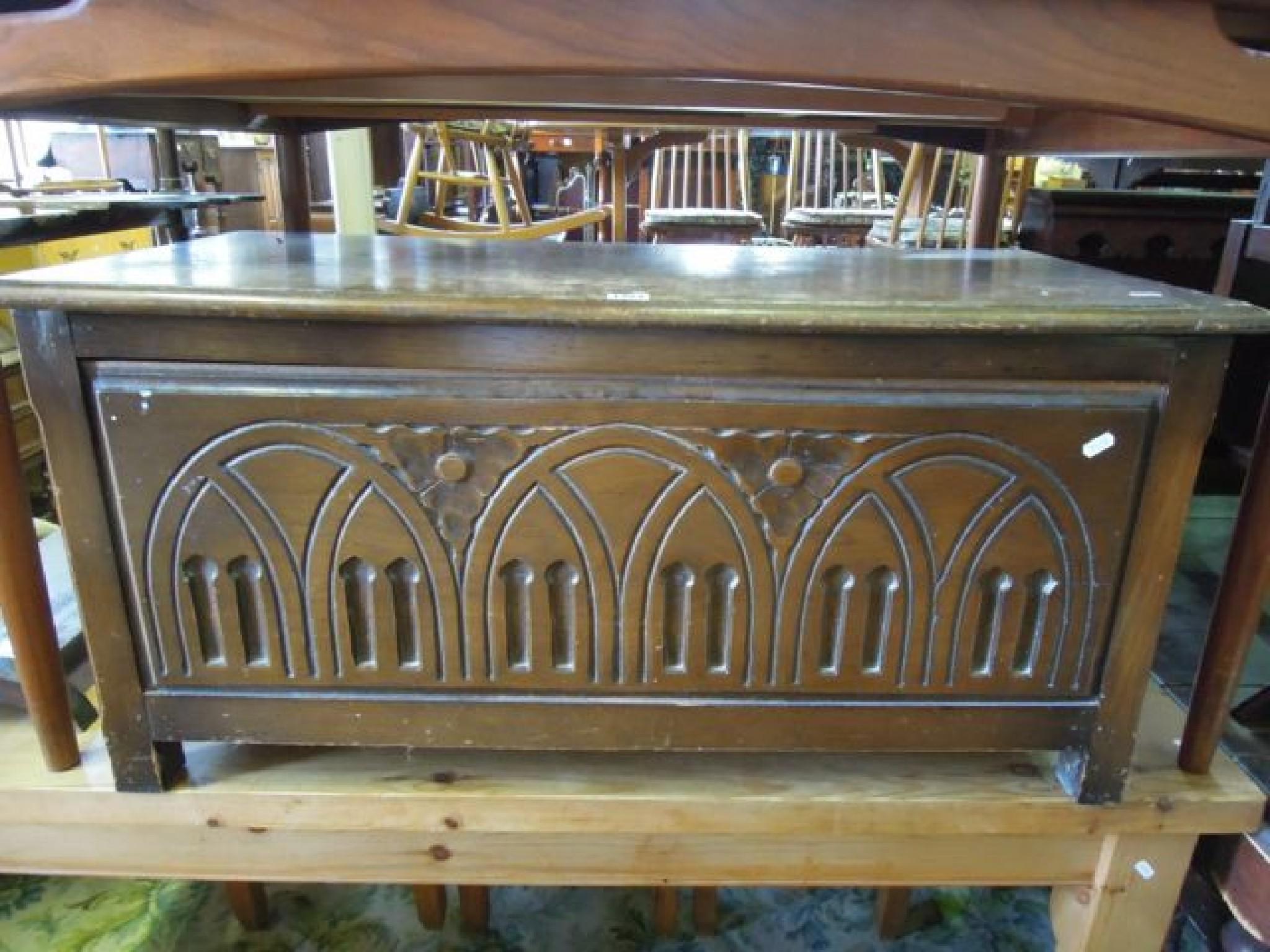 Appraisal: A reproduction oak coffer with carved detail