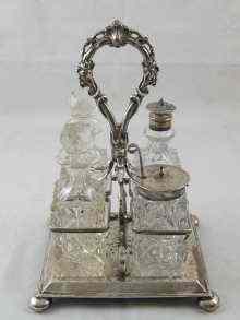 Appraisal: A four bottle cruet with silver mounts and stand Stand