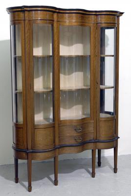 Appraisal: AN EDWARDIAN MAHOGANY DISPLAY CABINET of oblong serpentine form crossbanded