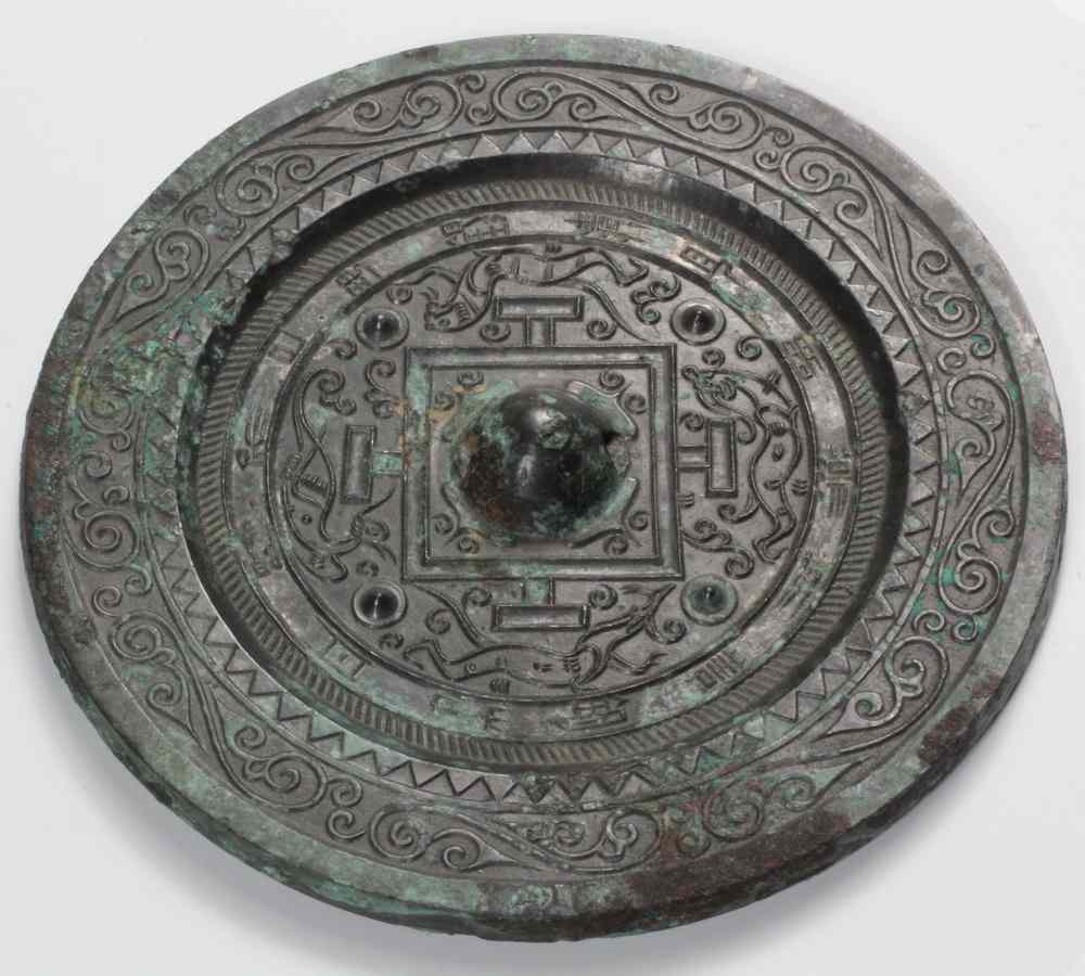 Appraisal: CHINESE SILVERED BRONZE MIRROR-HAN DYNASTY- A central knob rising from