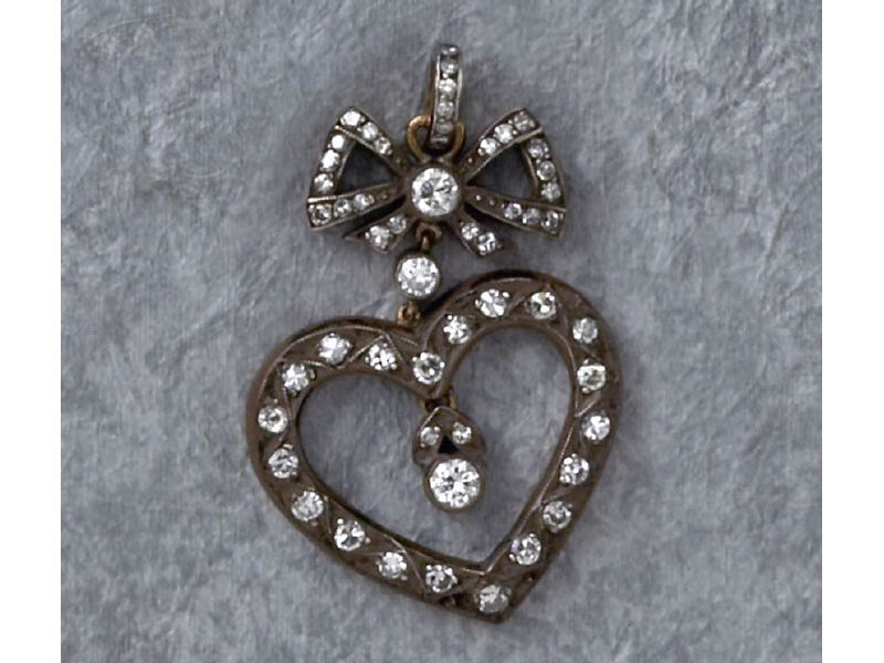 Appraisal: DIAMOND HEART PENDANT k yellow gold silver topped heart pendant