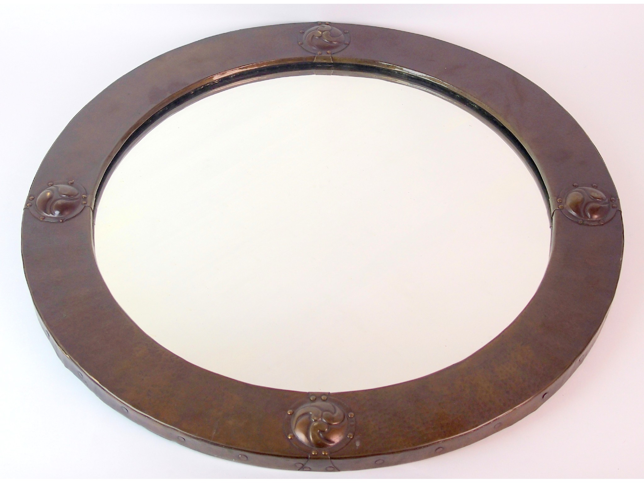 Appraisal: A Liberty Co circular patinated copper brass mirrorthe mirror edge